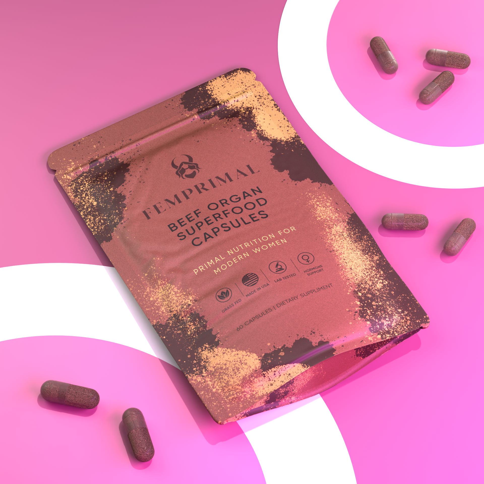 FEMPRIMAL Beef Organ Superfood Capsules flat lay packaging with scattered capsules on a pink background representing vitality and natural nutrition.