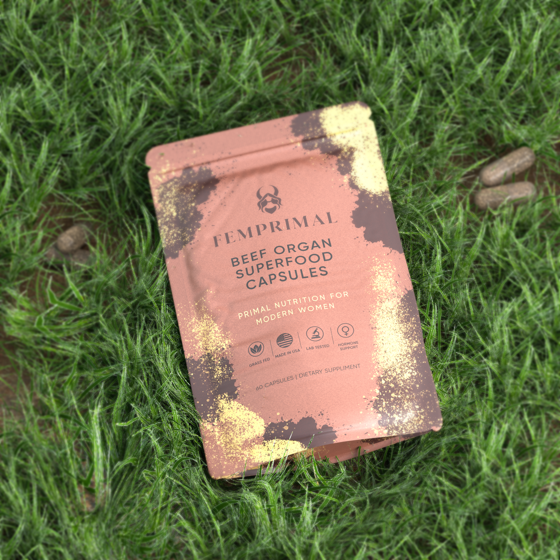 FEMPRIMAL Beef Organ Superfood Capsules pouch on natural green grass background highlighting grass-fed, hormone-free ingredients made for modern women.